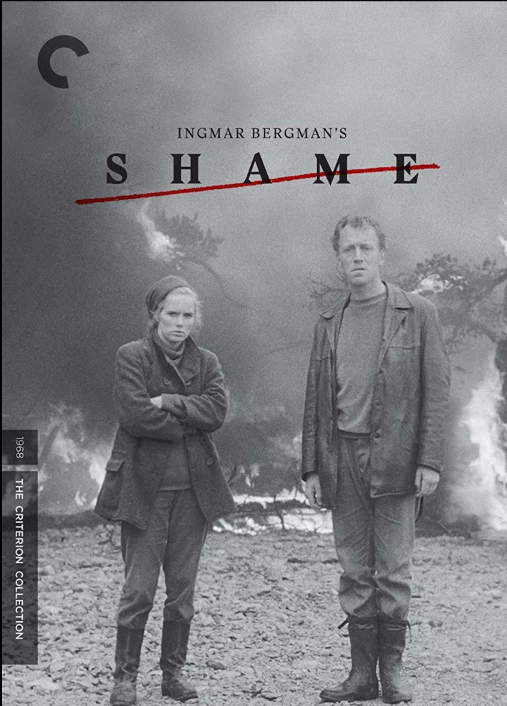 A promotional poster for Ingmar Bergman's film 'Shame.' The image shows two characters standing amidst a bleak landscape with smoke and fire in the background. The film title 'SHAME' is prominently displayed, with a red line crossing through it.